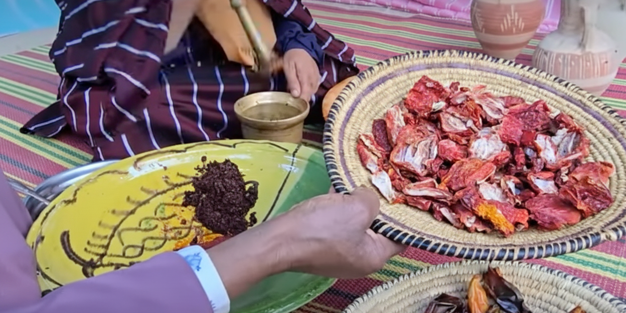Dried fruits on a woven tray with a colorful tablecloth
